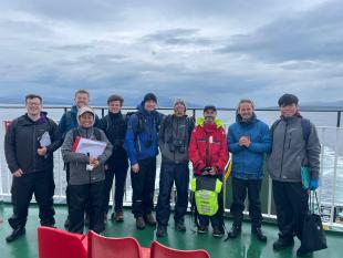 Ariff and colleagues A small group of students on the deck of a ferry at sea