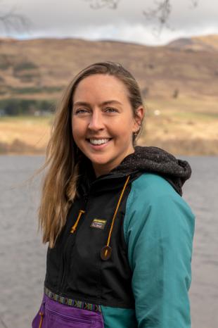 photo of Eve Andrews with loch and mountains in background