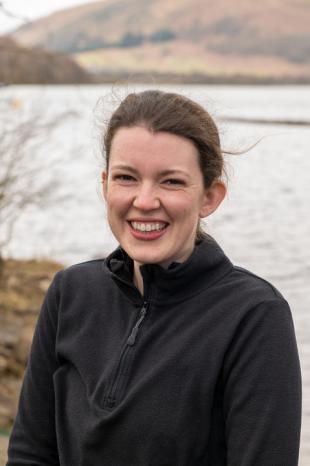 photo of Ione Smith with sea and mountains in background