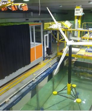 Researching waves and floating offshore wind platforms A model offshore wind turbine in a wave tank research facility